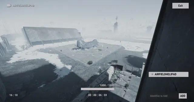 AIRFIELDHELIPAD camera, Airfield: a wrecked aircraft on a square pad beside a hangar