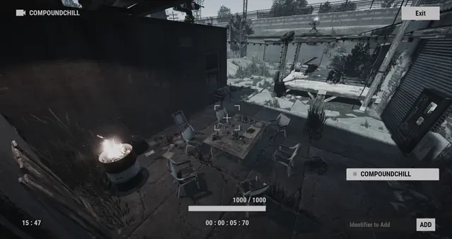 COMPOUNDCHILL camera, Outpost: chairs around a table beside a fire barrel